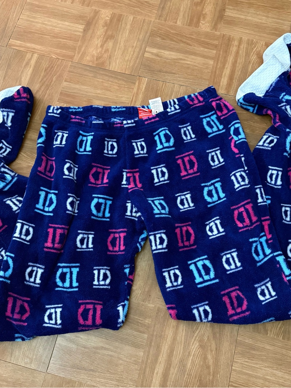 One Direction fleece PJs, women’s M. Cozy footed design with colorful 1D print.